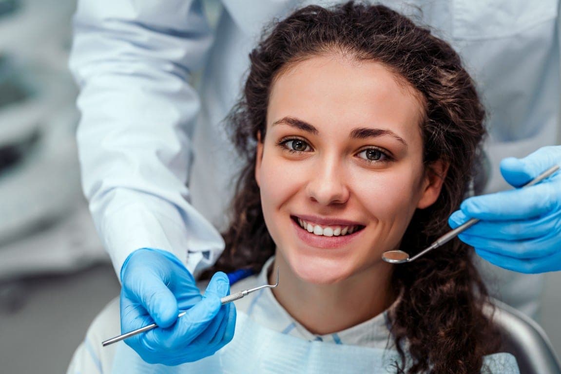 A patient smiling during a routine check-up