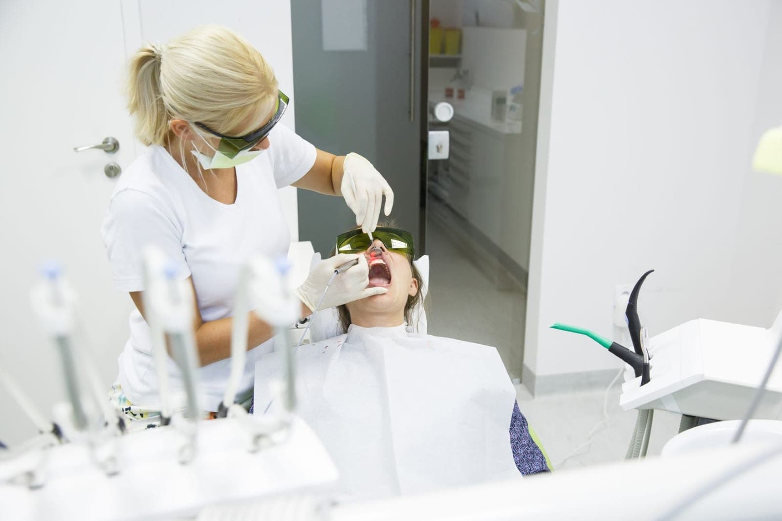 A clinician at work in a treatment room set up for laser therapy