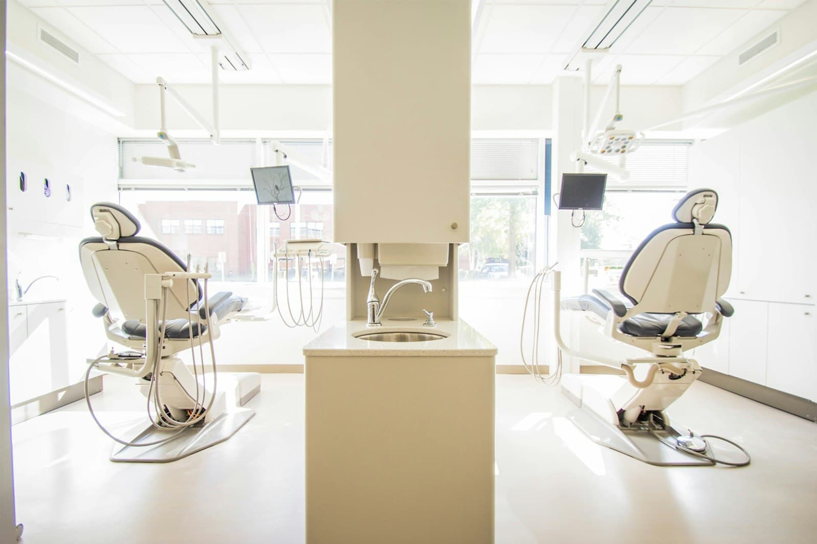 Two dental treatment rooms sharing a daylit workspace