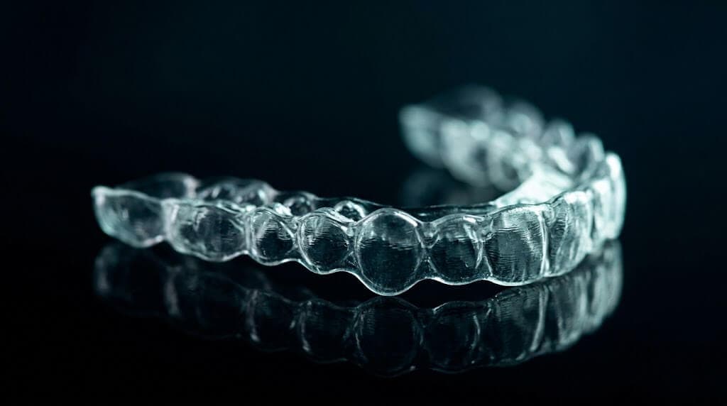 Clear aligners consultation near me: dentist reviewing a 3D digital bite scan with a patient in Wylie TX