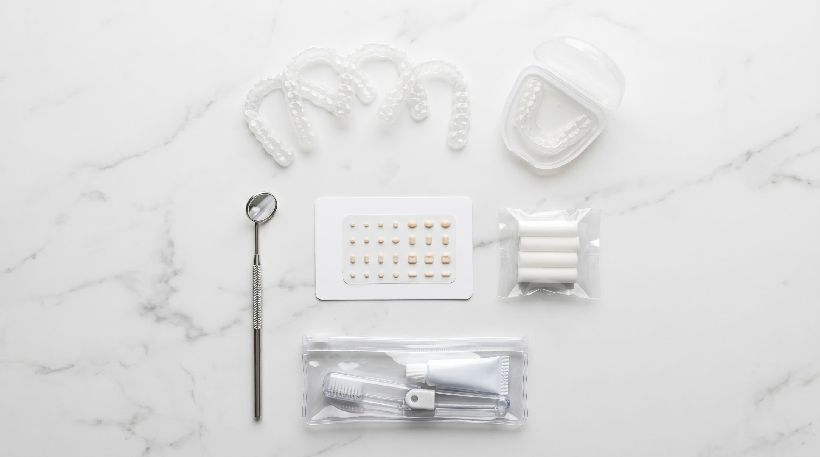 Smiling Patient Holding Clear Invisalign Aligner Tray